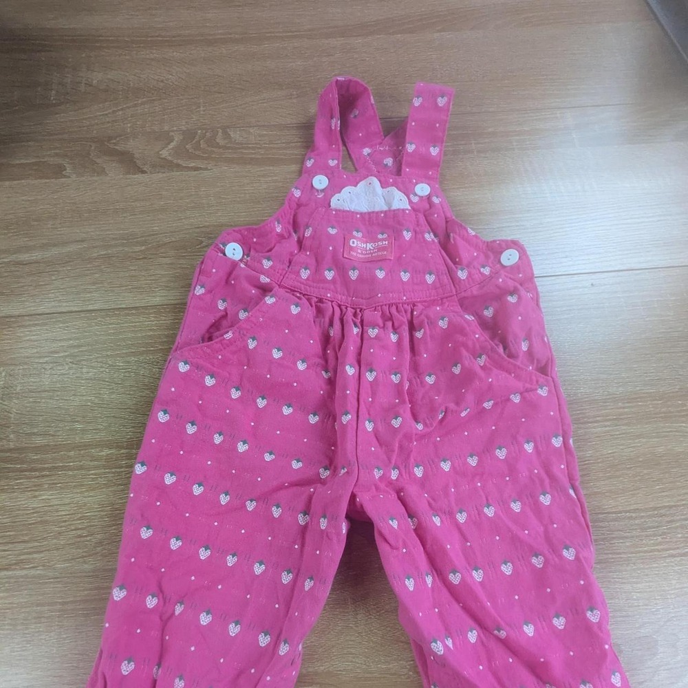 Pink OshKosh B'gosh overalls with strawberry pattern